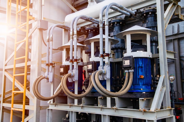 Row of electric motor water pumps and pipeline system in industrial factory. Maintenance and engineering concept.