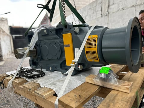 Industrial fan blower with yellow and black casing mounted on wooden pallet with lifting straps